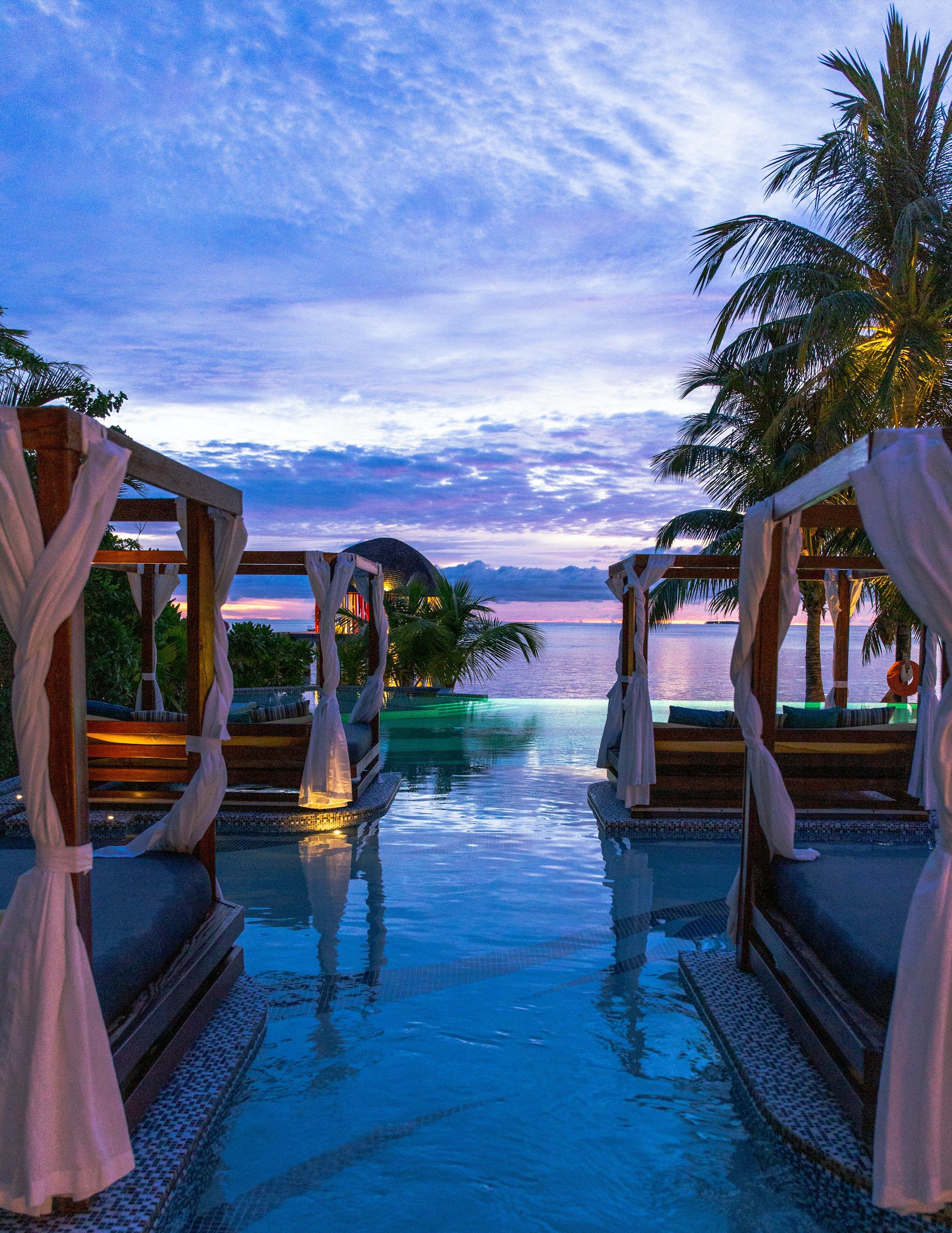 An infinity pool overlooking the ocean at sunset